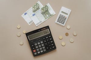 Flat lay of calculators and Euro currency, depicting financial calculations and budget management.